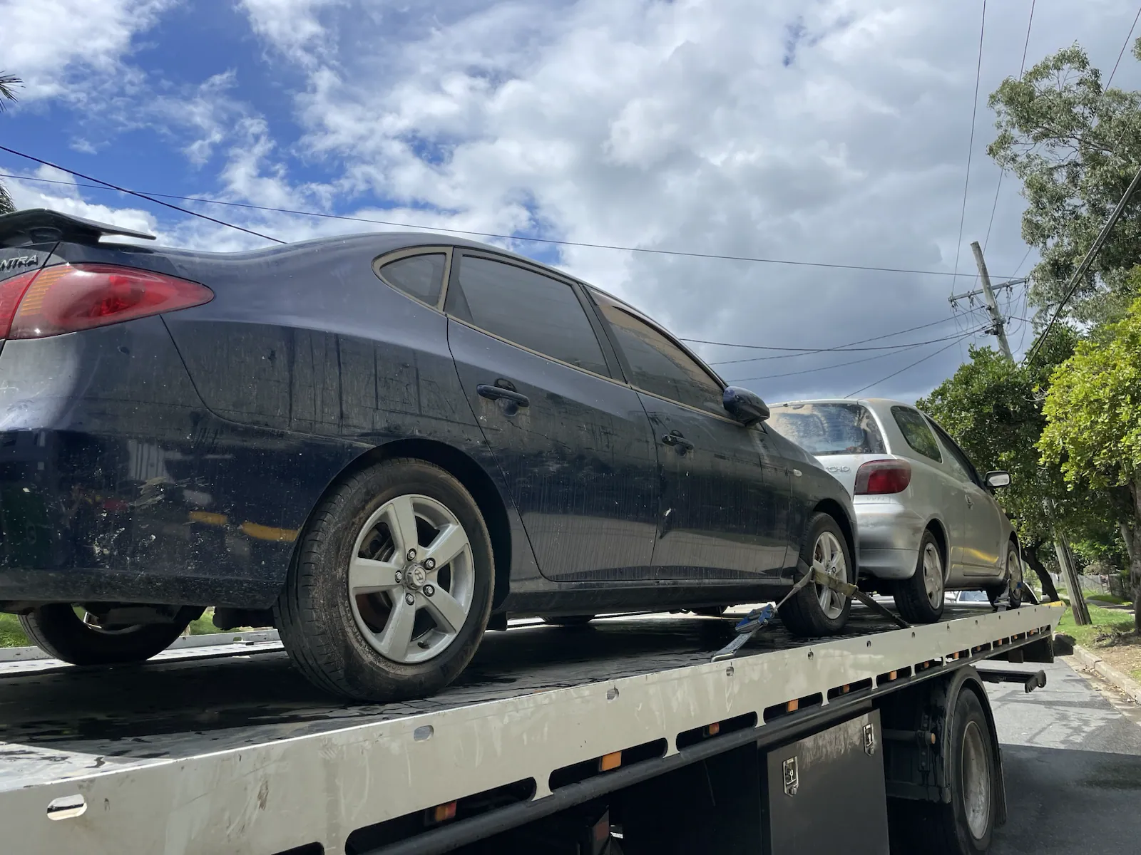 Black sedan loaded for unwanted car removal in Queensland