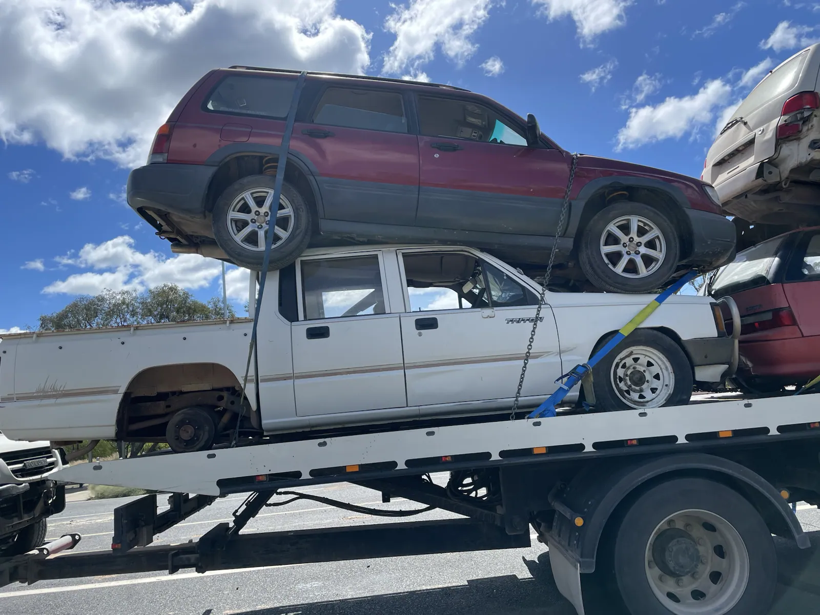 Mixed ute and SUV vehicles loaded for removal