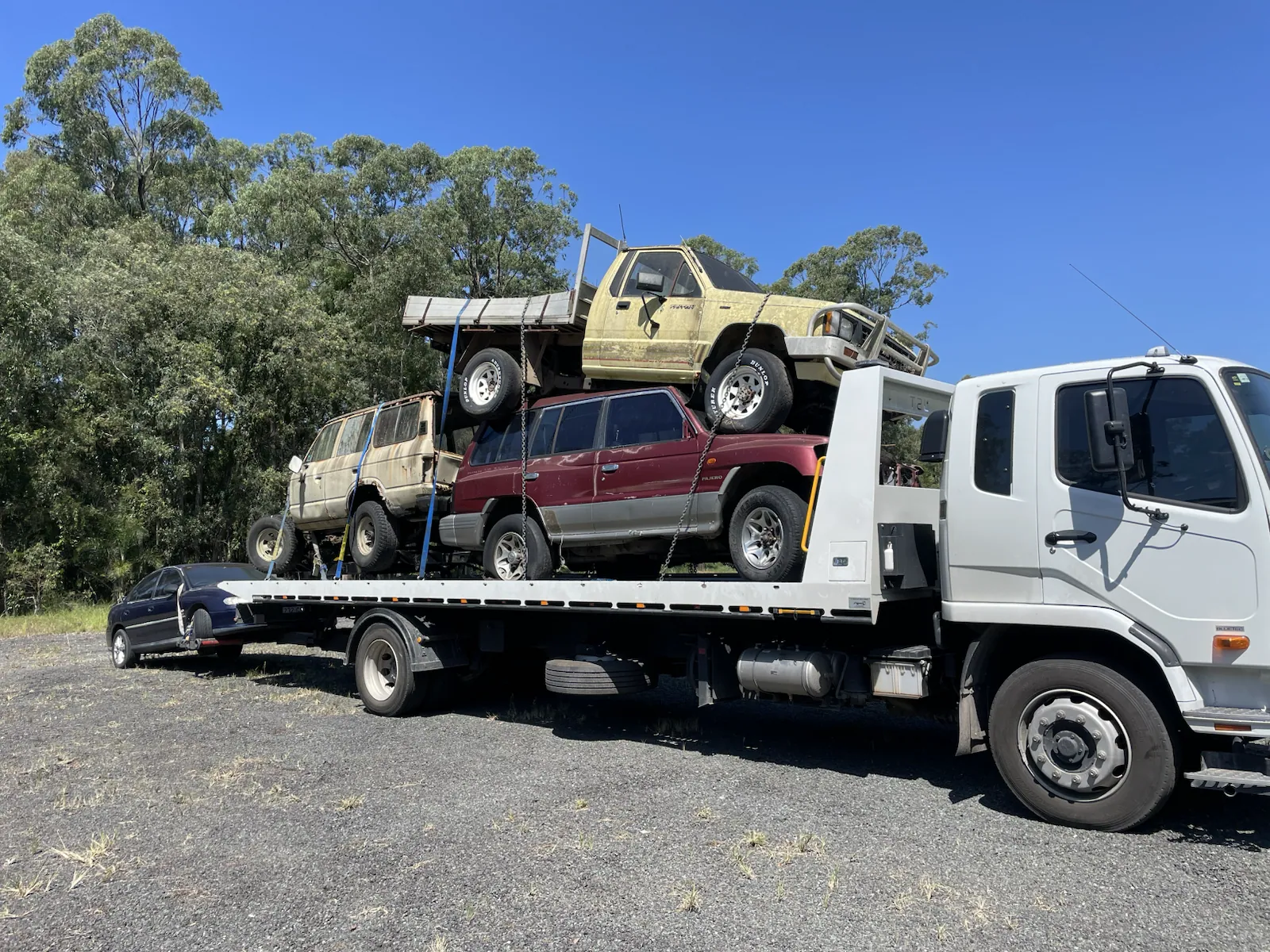 Mixed cars and utes loaded for vehicle removal in Queensland