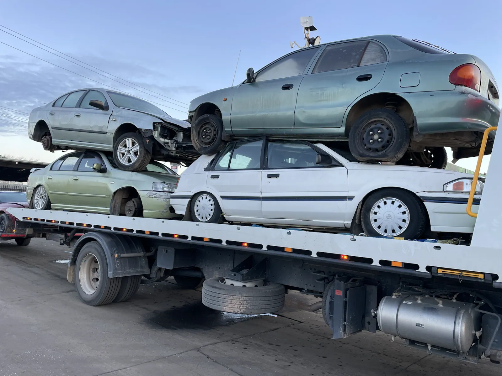 White sedan and SUV on a removal truck in Queensland